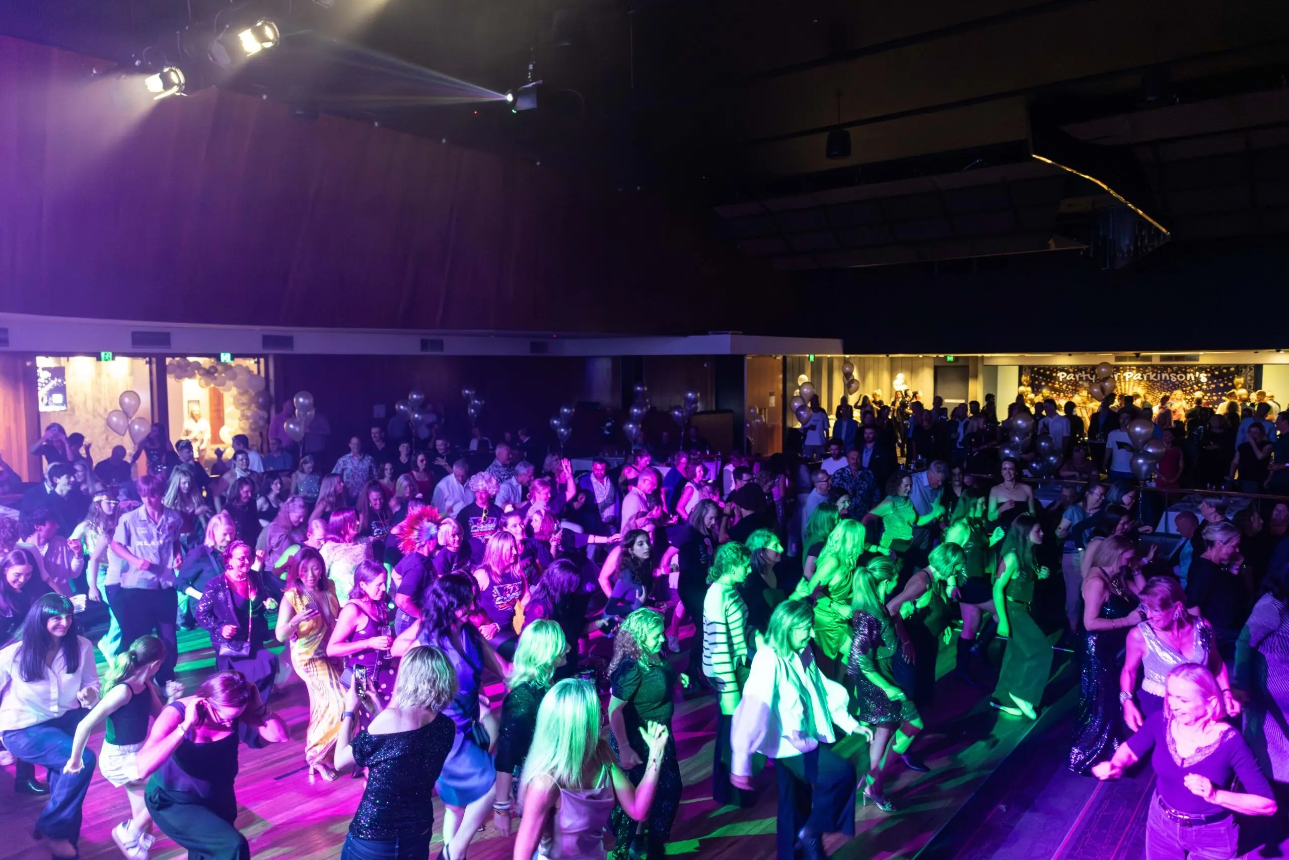 Photo of a large group of people performing a synchronized dance